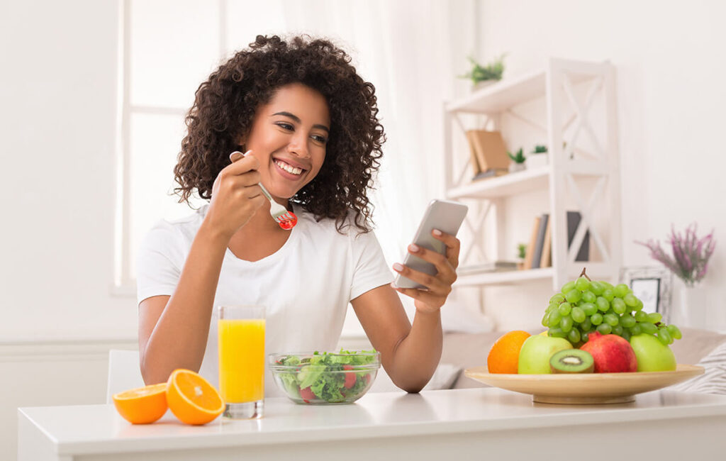 young woman eating healthy fruits